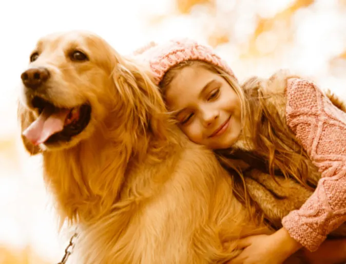 Girl Hugging Golden Retriever